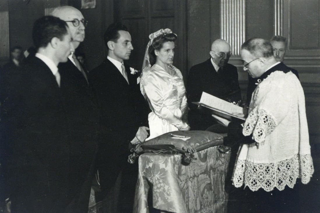 Historical image of Jesuit priest and bride and groom during a wedding celebration