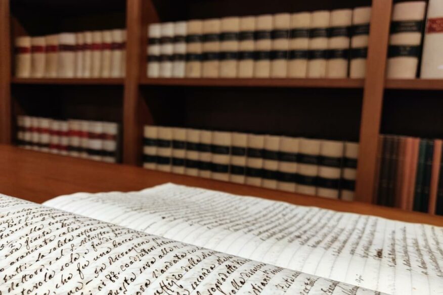 Detail of a document and bookcase with catalogues stored in the Historical Archives of the Jesuit Euro-Mediterranean Province in Rome