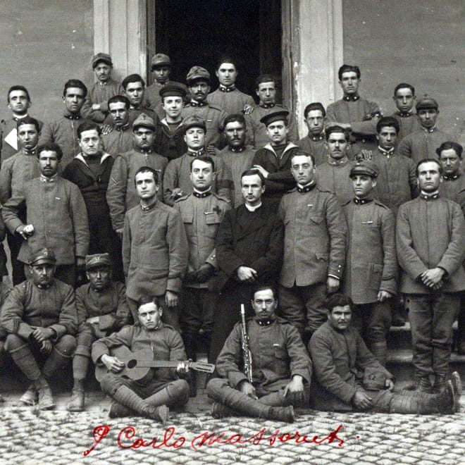 Photograph of Fr. Carlo Massaruti with a group of soldiers